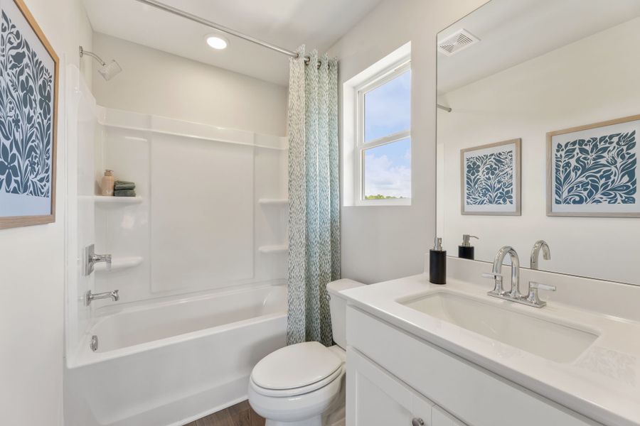 A bathroom with a tub sink and toilet. A bathroom with a tub sink and toilet.