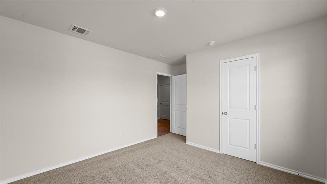 Carpeted interior space with light neutral wall paint Carpeted interior space with light neutral wall paint
