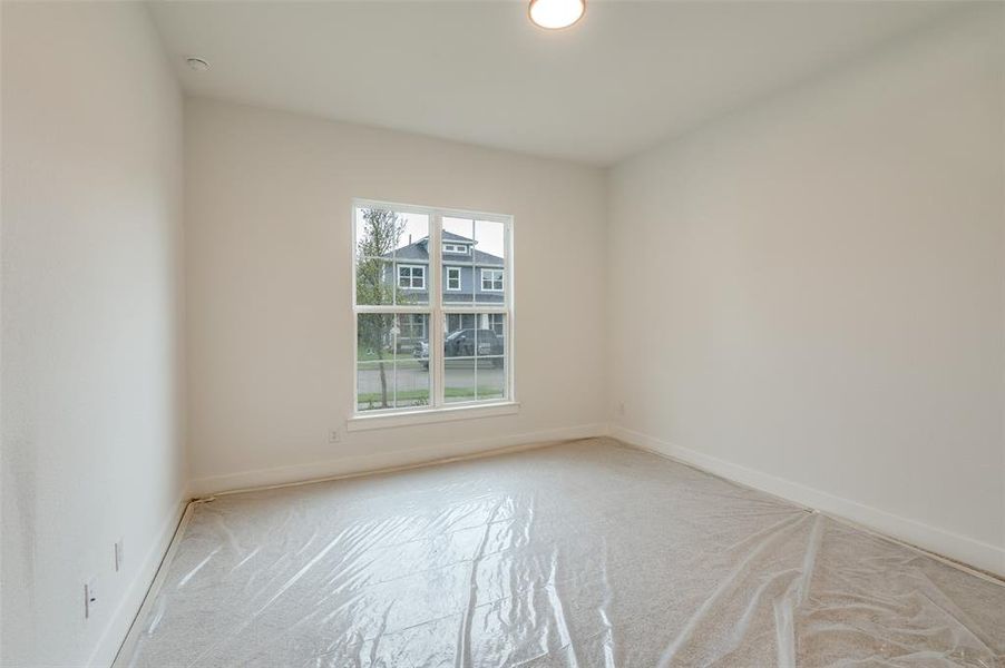 Carpeted empty room featuring a wealth of natural light