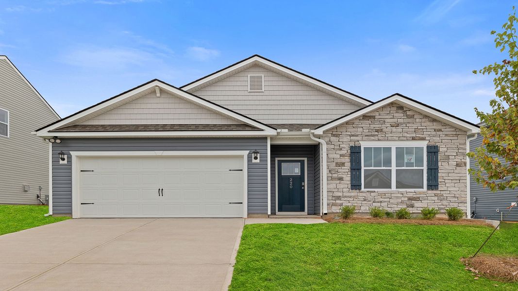 Front exterior of a new home in Durbin Meadows Traditions, Fountain Inn, SC, highlighting curb appeal (Image 1).