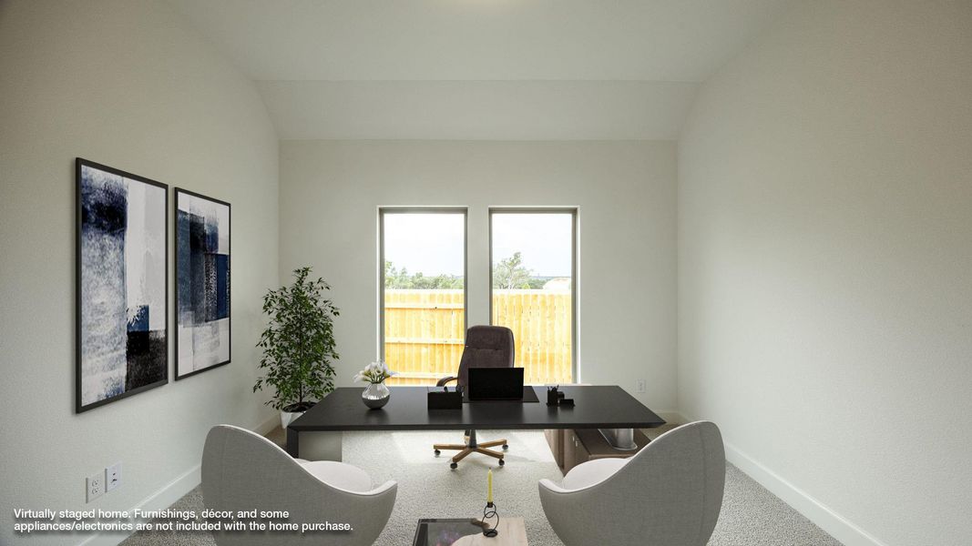 Carpeted home office with baseboards and lofted ceiling