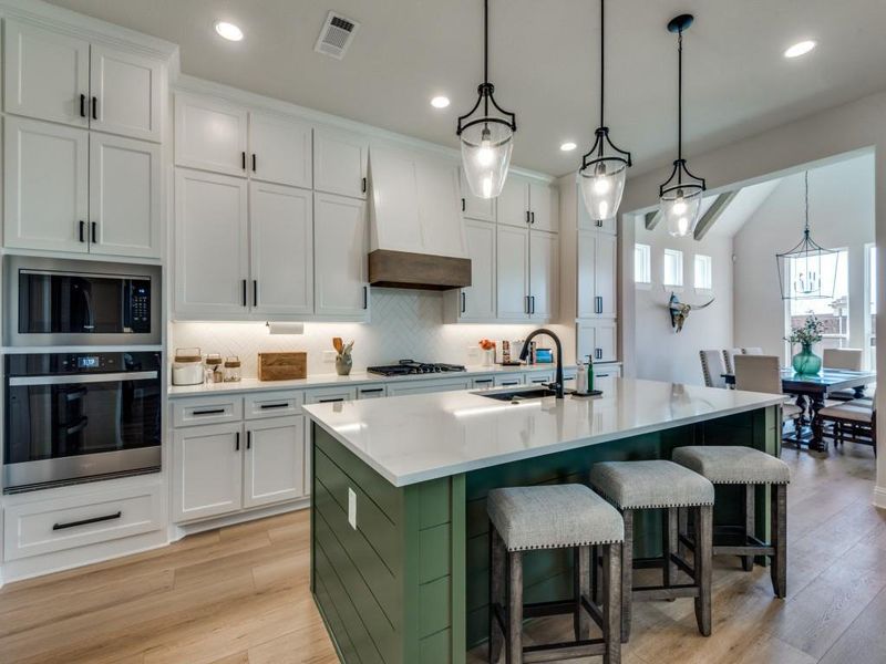 Kitchen with appliances with stainless steel finishes, white cabinets, and sink