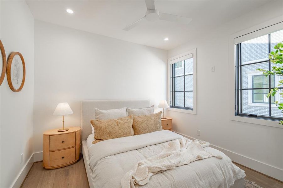 Bedroom with ceiling fan and hardwood / wood-style flooring