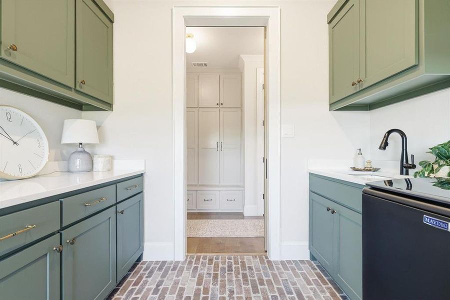 Laundry room with closet to left. Beautiful brick floor Laundry room with closet to left. Beautiful brick floor