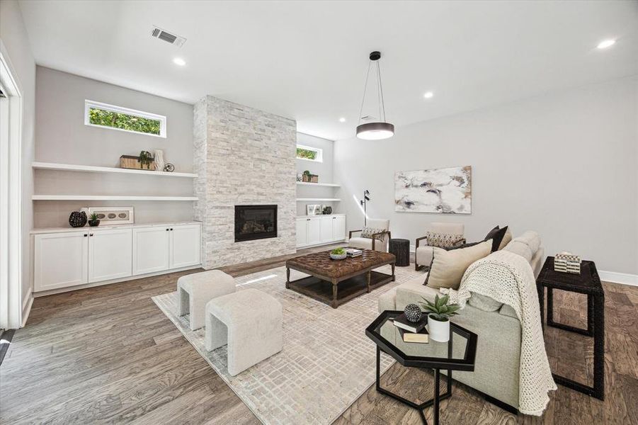 Handsome built-ins, shelves and recessed lighting highlight the  spacious Great Room