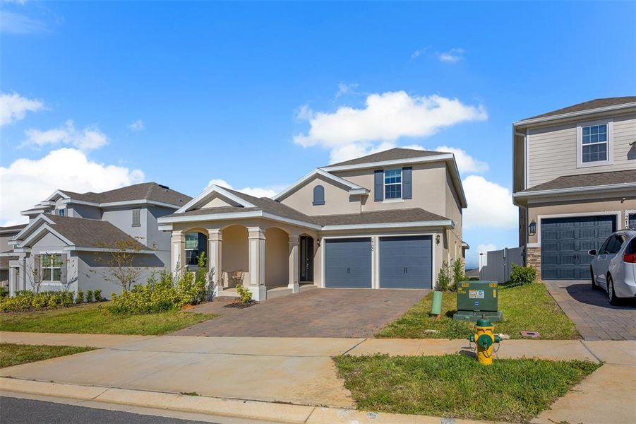 Front exterior of a new home in , Minneola, FL, highlighting curb appeal (Image 25). Front exterior of a new home in , Minneola, FL, highlighting curb appeal (Image 25).