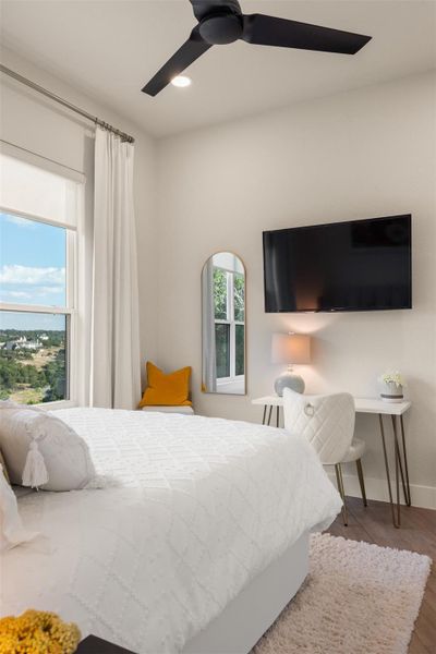 Bedroom with ceiling fan and hardwood / wood-style floors Bedroom with ceiling fan and hardwood / wood-style floors