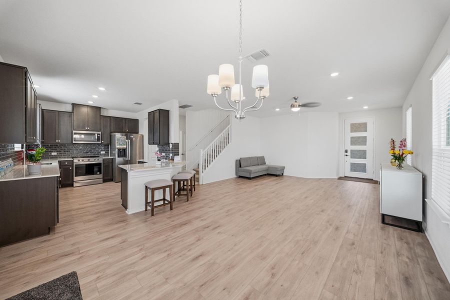 An open-concept living space with a contemporary kitchen and durable flooring provides seamless flow for daily living. An open-concept living space with a contemporary kitchen and durable flooring provides seamless flow for daily living.
