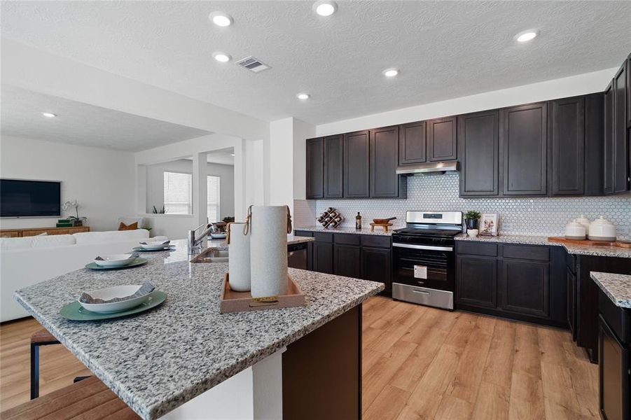 Kitchen displaying the beautiful colors of the granite countertop!