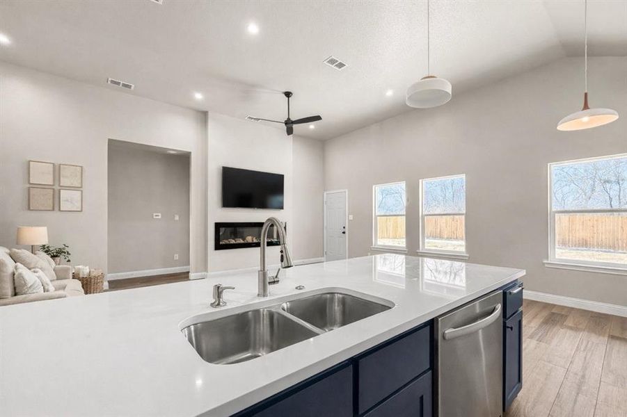 Half bath with vanity, a textured wall, and wood finished floors