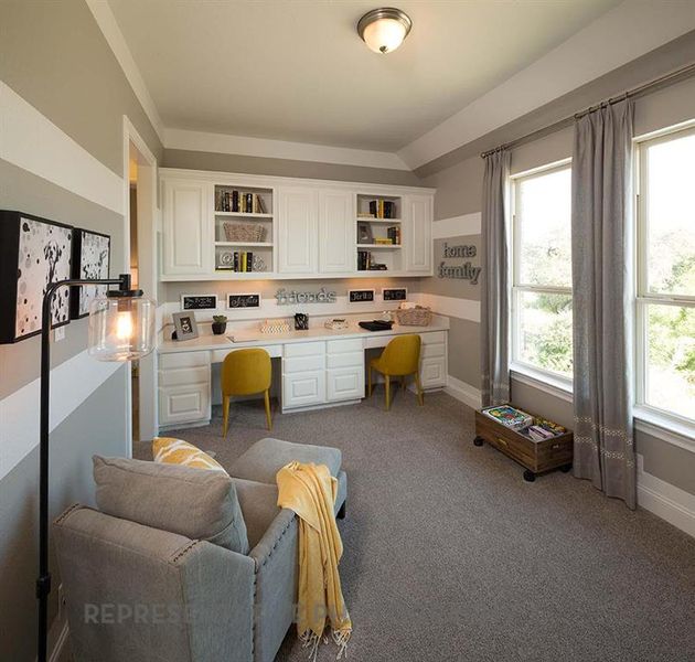 Office area with built in study area and dark carpet Office area with built in study area and dark carpet