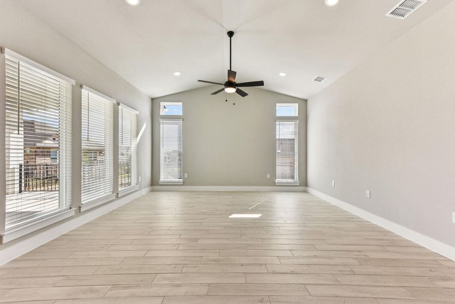 Unfurnished room with light wood-type flooring, recessed lighting, ceiling fan, and vaulted ceiling