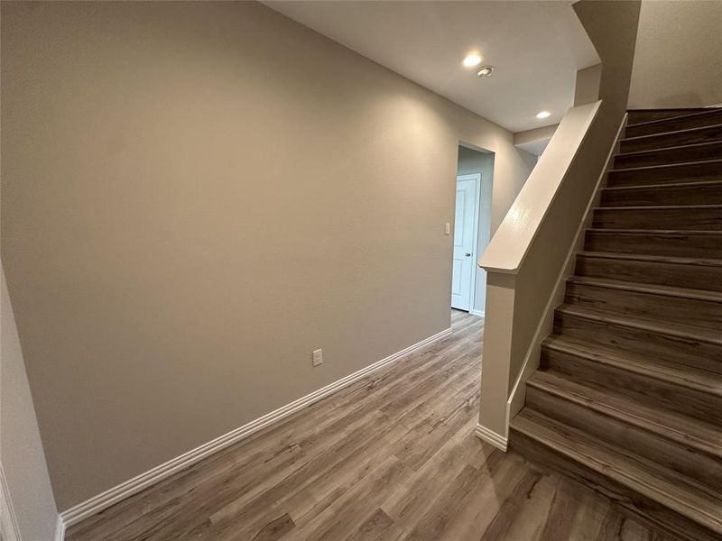 Stairs with hardwood / wood-style flooring