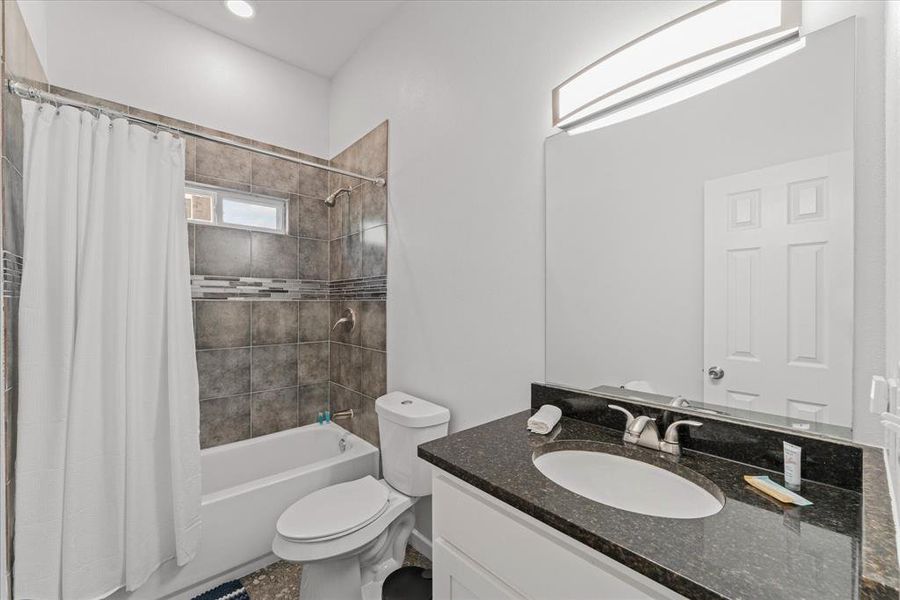Bathroom featuring shower / tub combo and vanity