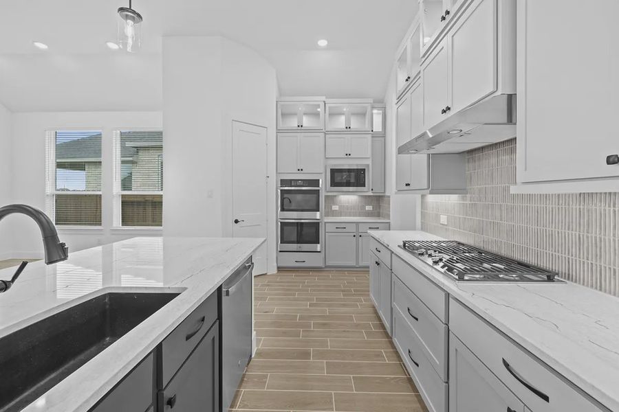 Representative furnished interior of a home built from the Summerton by Chesmar Homes in University Heights, Round Rock (Image 9).