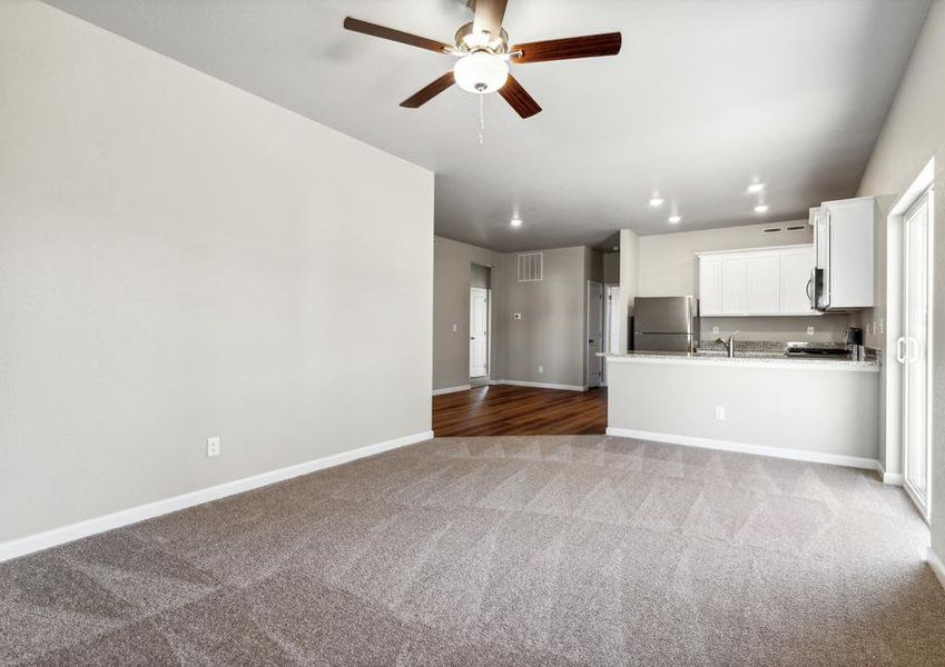 The family room is spacious and has a ceiling fan.