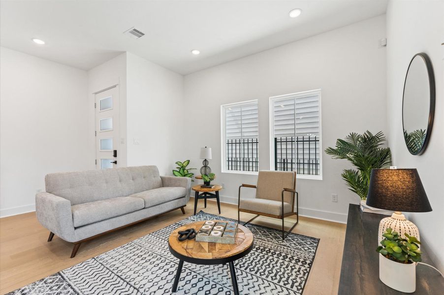 This welcoming living area blends comfort and style with an open layout and abundant natural light. Large windows create a bright, airy atmosphere, while neutral tones and warm finishes set a relaxing mood. Whether you're hosting guests or enjoying a quiet evening, the space offers flexible seating and a seamless connection to adjacent rooms—perfect for modern living. This welcoming living area blends comfort and style with an open layout and abundant natural light. Large windows create a bright, airy atmosphere, while neutral tones and warm finishes set a relaxing mood. Whether you're hosting guests or enjoying a quiet evening, the space offers flexible seating and a seamless connection to adjacent rooms—perfect for modern living.