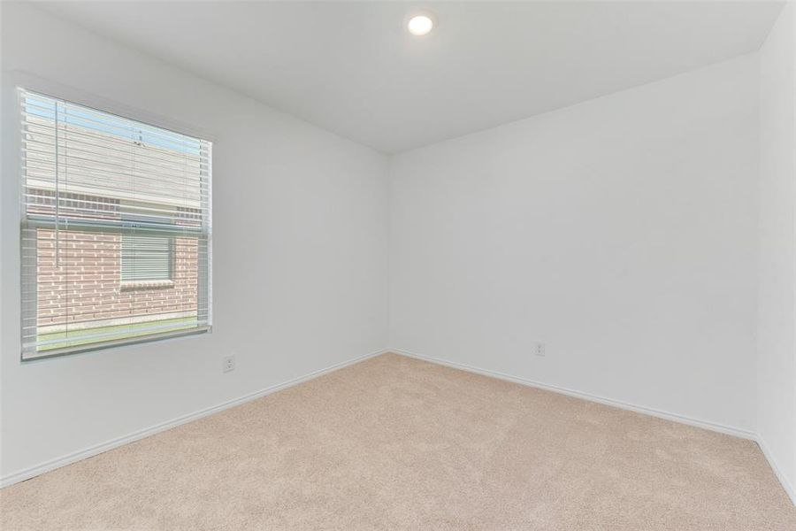 Empty room with light carpet and a healthy amount of sunlight