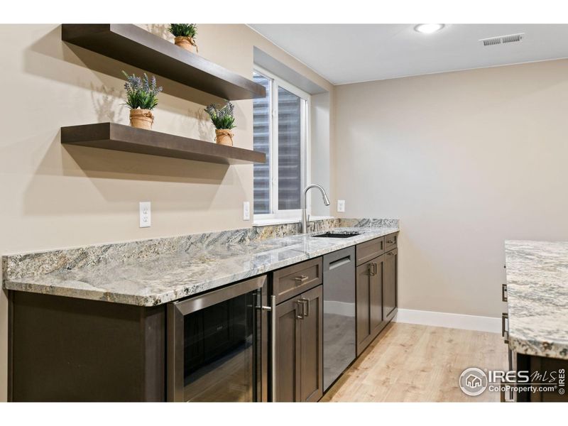 Mini fridge and dishwasher add convenience in this wet bar