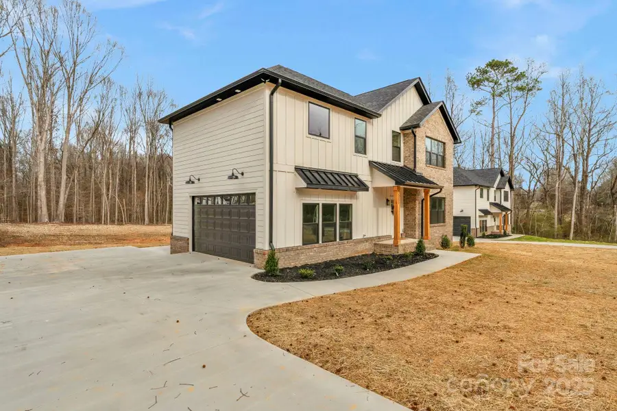 Front exterior of a new home in , Waxhaw, NC, highlighting curb appeal (Image 1). Front exterior of a new home in , Waxhaw, NC, highlighting curb appeal (Image 1).