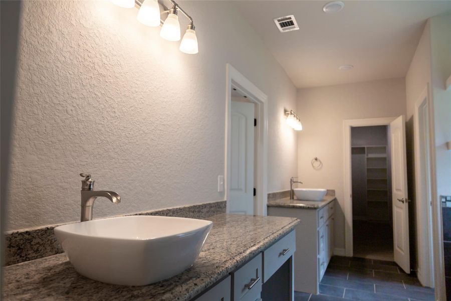 Sample Primary bath has vanity and double sinks with lots of cabinets space.