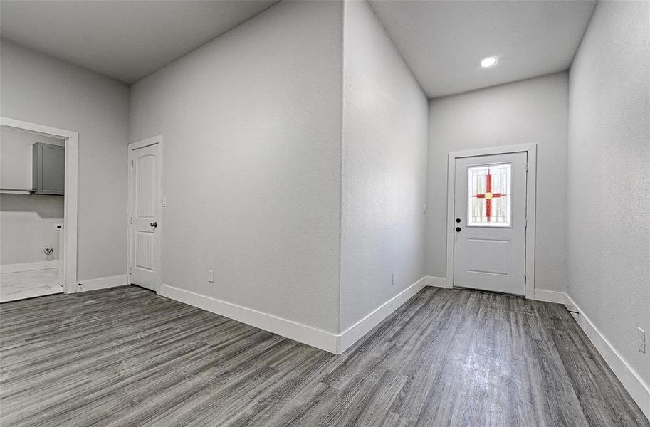 Foyer entrance with hardwood / wood-style flooring