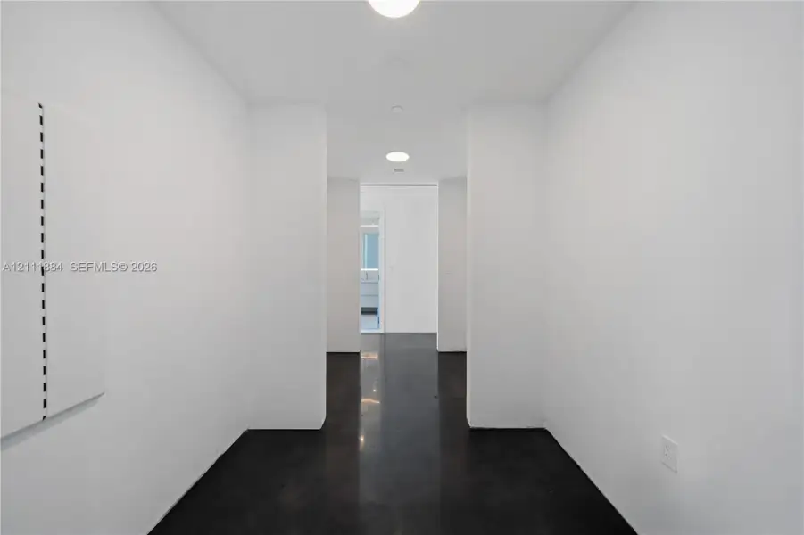 Polished concrete flooring, smooth white walls, and recessed ceiling lighting Polished concrete flooring, smooth white walls, and recessed ceiling lighting