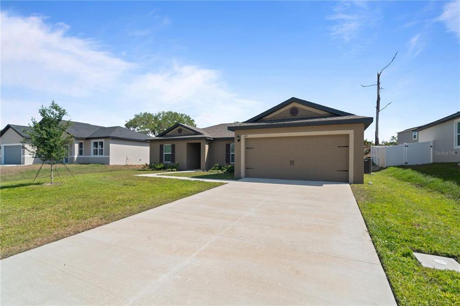 Front exterior of a new home in Poinciana, Poinciana, FL, highlighting curb appeal (Image 14).