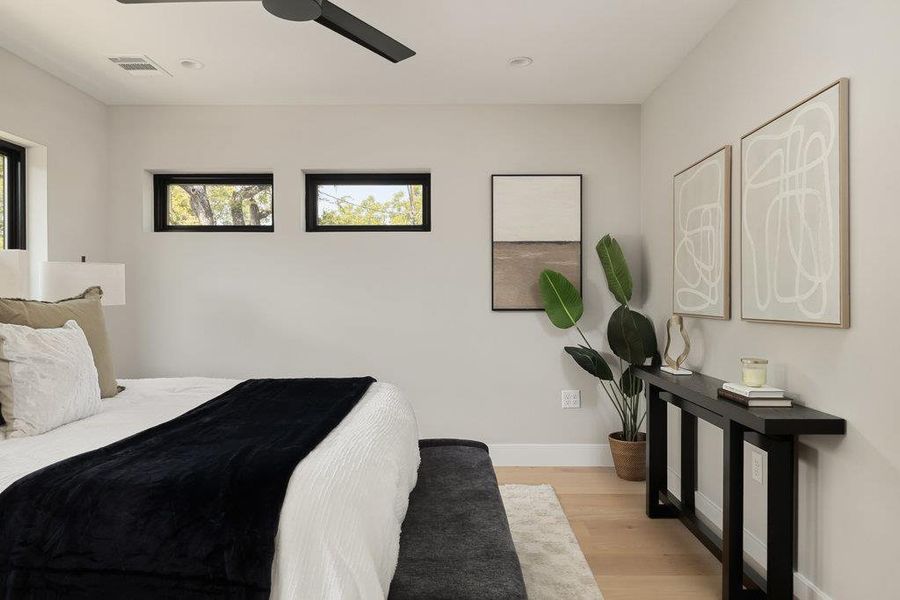 Bedroom featuring light wood finished floors, ceiling fan, and recessed lighting