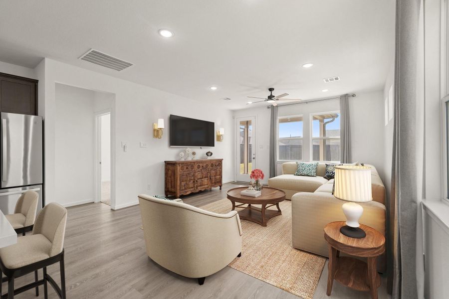 Gather the family and guests together in your huge living room! Featuring high ceilings, dark stained ceiling fan, gorgeous floors, and large windows that provide plenty of natural lighting throughout the day! *This room has been virtually staged