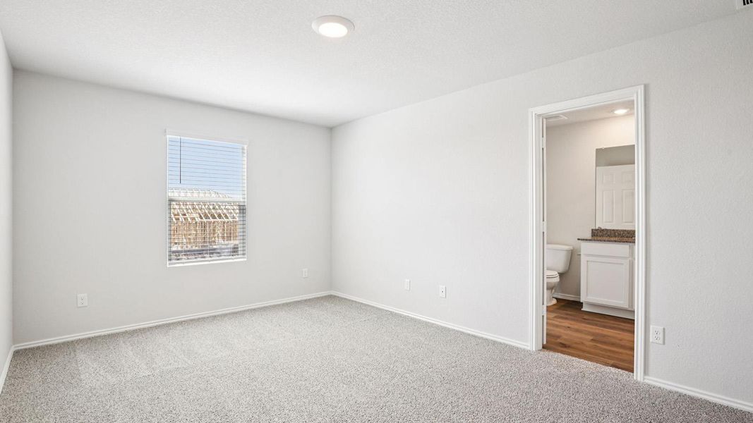 Spacious room featuring light gray carpet, a window with blinds, and white walls