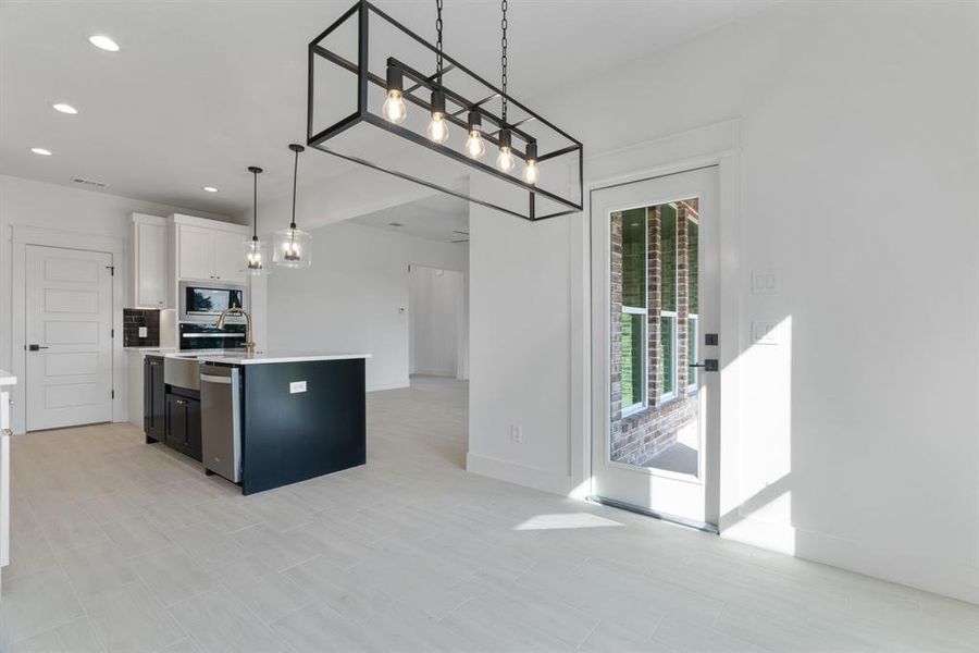 Unfurnished dining area with baseboards and light wood finished floors