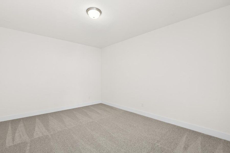 Carpeted spare room featuring baseboards Carpeted spare room featuring baseboards