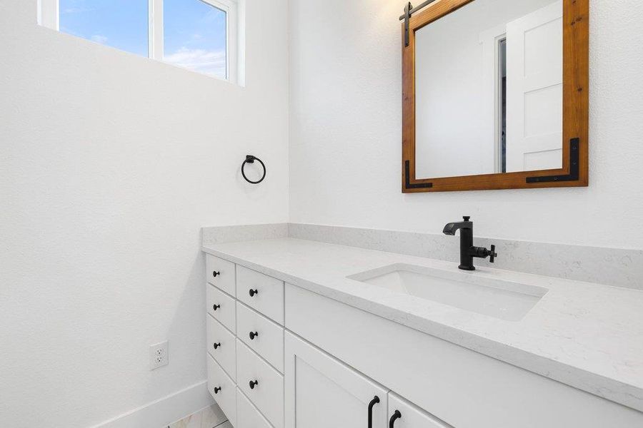 Bathroom with vanity and baseboards