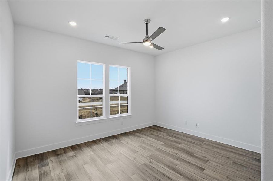 Empty room with light wood-style flooring, recessed lighting, and a ceiling fan