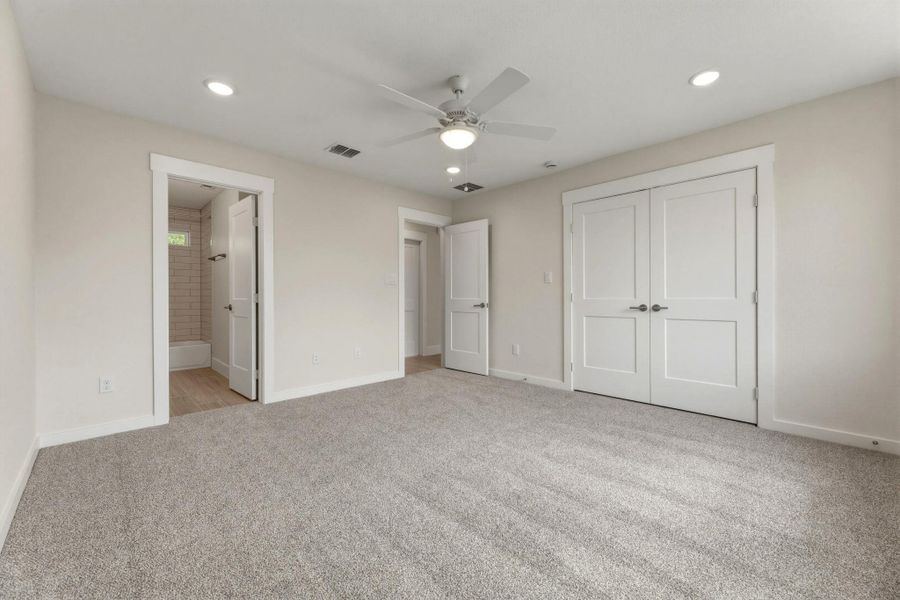 Bedroom of the guest quarters.  Nice sized closed and door to bathroom and hallway.