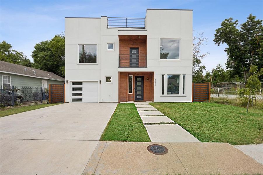 Modern home with a garage and a front yard