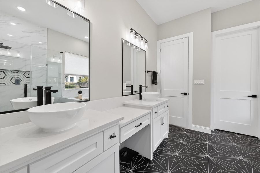 Primary bathroom with dual vanities and dedicated makeup area. Primary bathroom with dual vanities and dedicated makeup area.