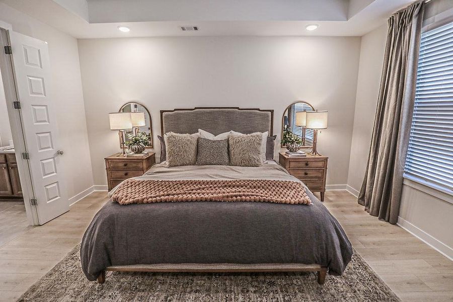Bedroom featuring light wood-style floors, recessed lighting, and ensuite bathroom