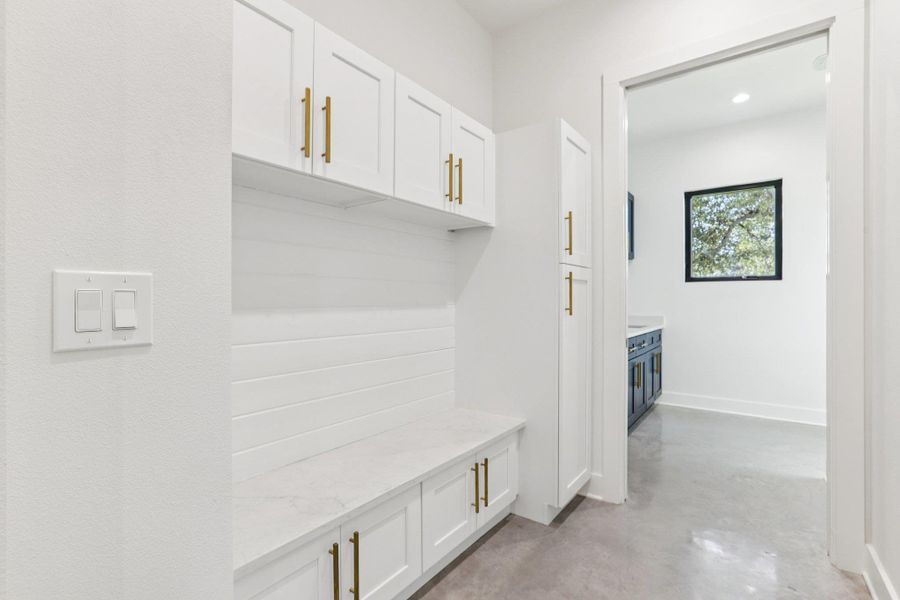 Designed for convenience, this dedicated laundry closet features full-size hookups and an overhead shelf for storage, keeping your essentials organized and out of sight