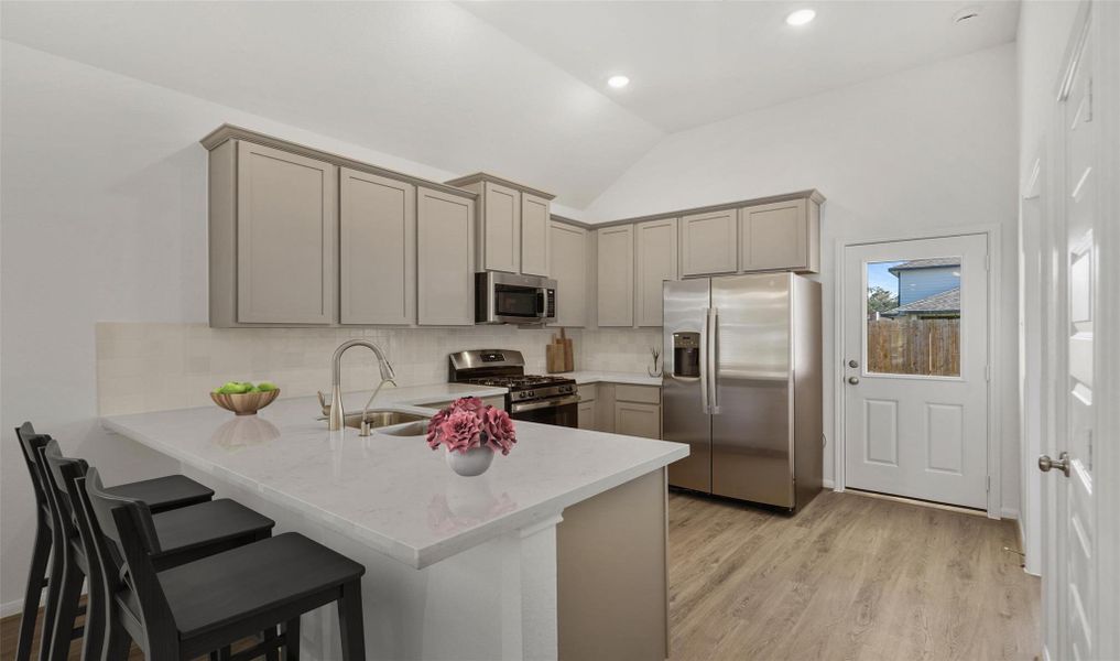 Stylish kitchen with lowered bar top for casual eating (*Photo not of actual home and used for illustration purposes only.)