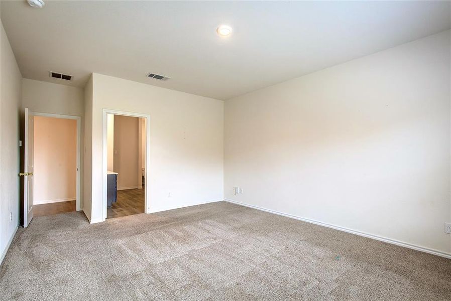 Unfurnished bedroom with carpet and baseboards