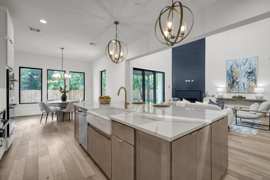 Wide view of the kitchen and family area for seamless entertaining. Wide view of the kitchen and family area for seamless entertaining.