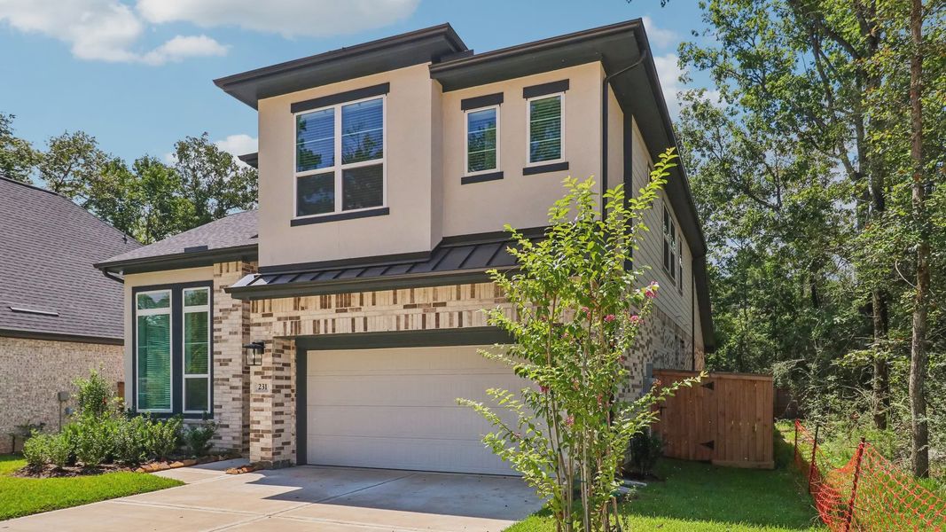 Front exterior of a new home in The Woodland Hills 50', Willis, TX, highlighting curb appeal (Image 21). Front exterior of a new home in The Woodland Hills 50', Willis, TX, highlighting curb appeal (Image 21).