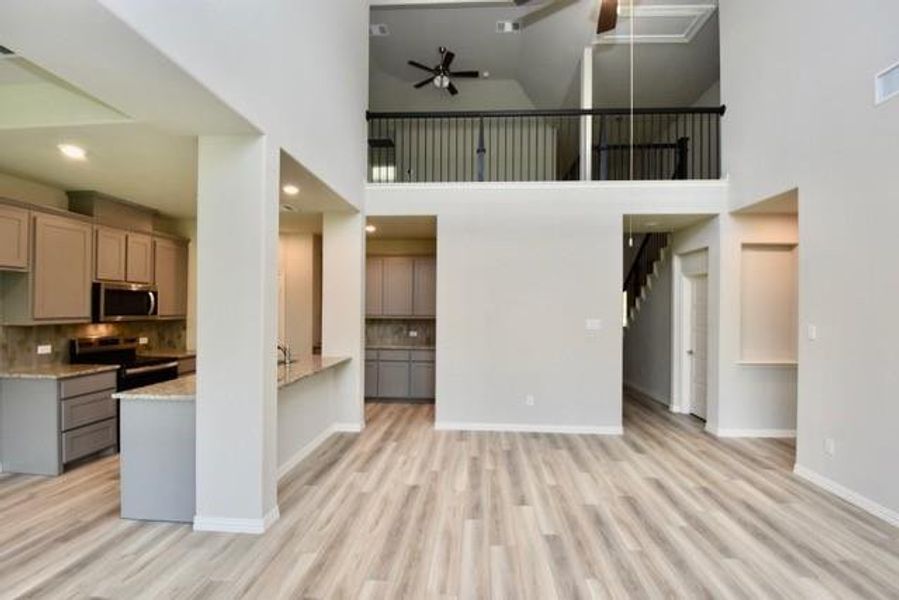 Open concept family room-kitchen with a view of the upstairs loft