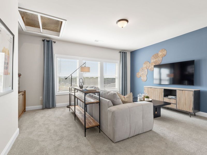 The upstairs media room is perfect for hosting movie nights.