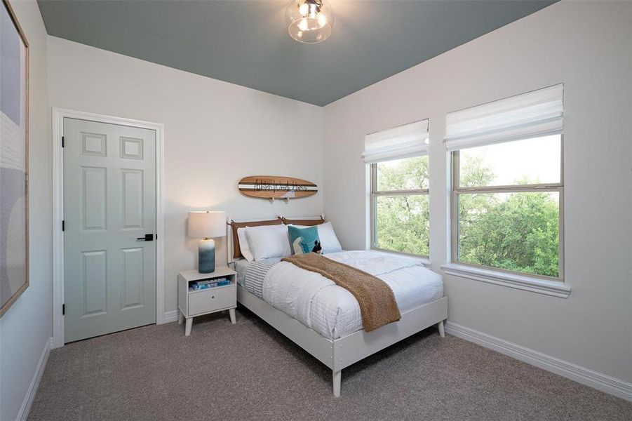 Your secondary bedroom features plush carpet, fresh paint, closet, and a large window that lets in plenty of natural lighting.