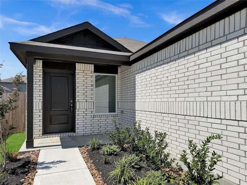 Exterior details and patio area of a home in Sweetgrass Village: Cottage Collection, Crosby (Image 2).