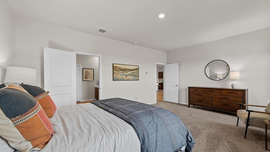 Spacious room with light grey walls, grey carpet, and recessed lighting Spacious room with light grey walls, grey carpet, and recessed lighting