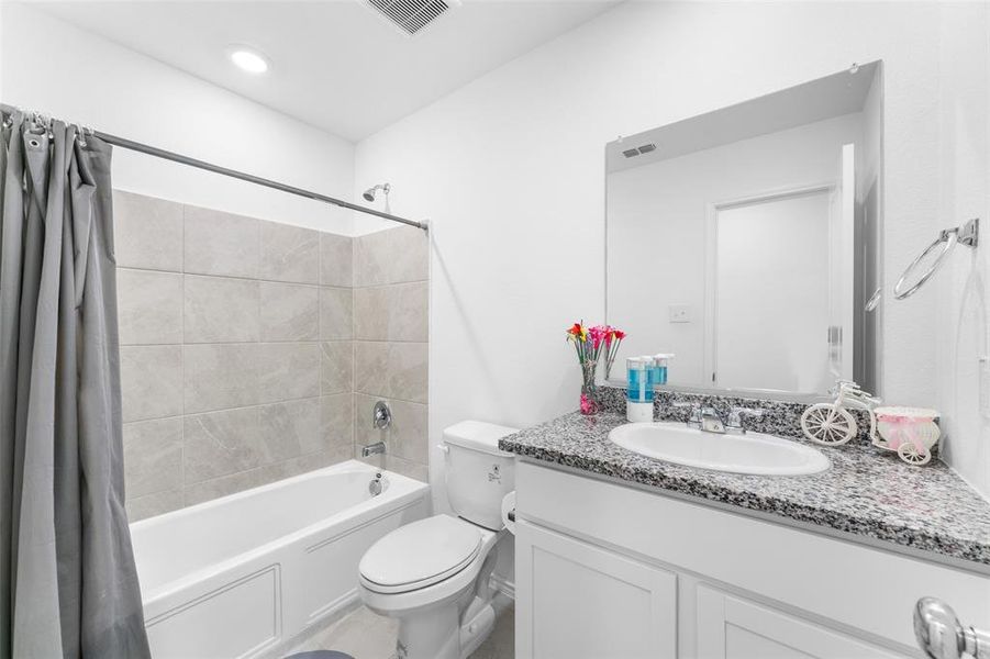 Full bath featuring shower / bath combo with shower curtain and vanity Full bath featuring shower / bath combo with shower curtain and vanity